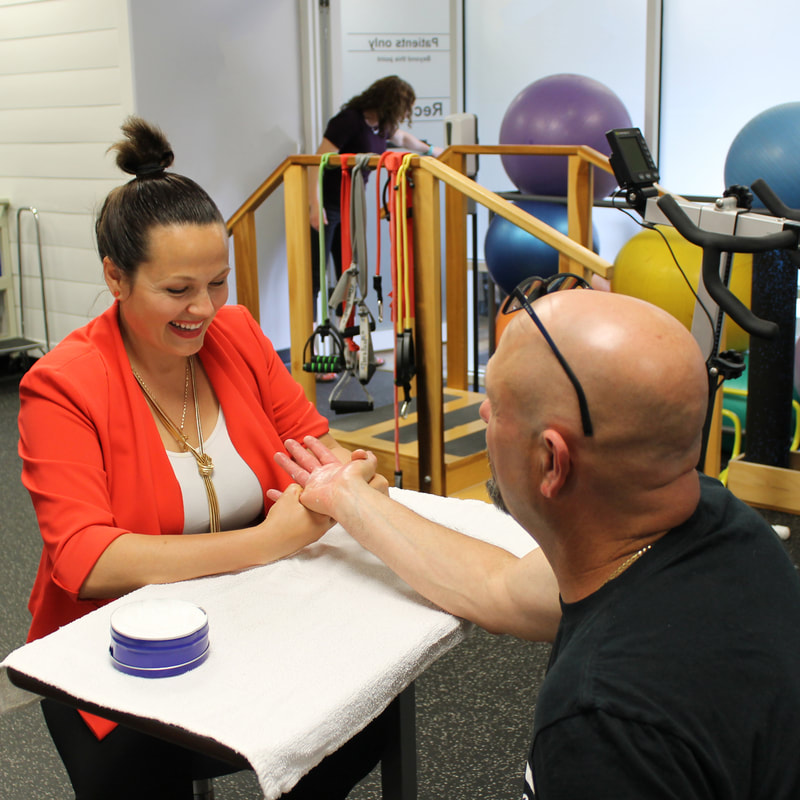Physical therapist treating back pain patient